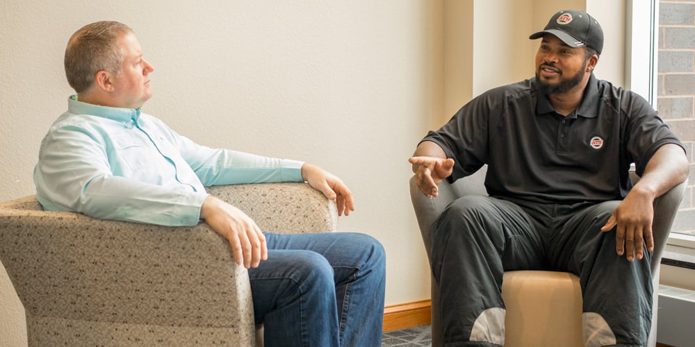 Two-Men-Talking-in-Chairs